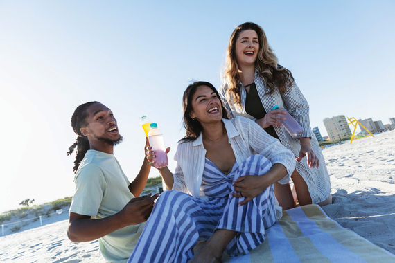 Group on the beach enjoying drinks and relaxing