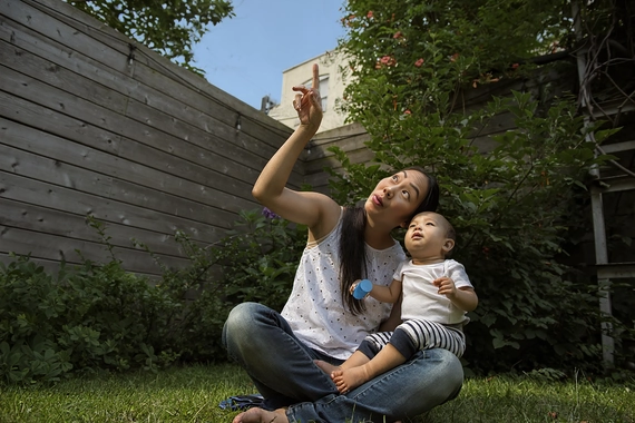 Parent sitting in a garden with their baby